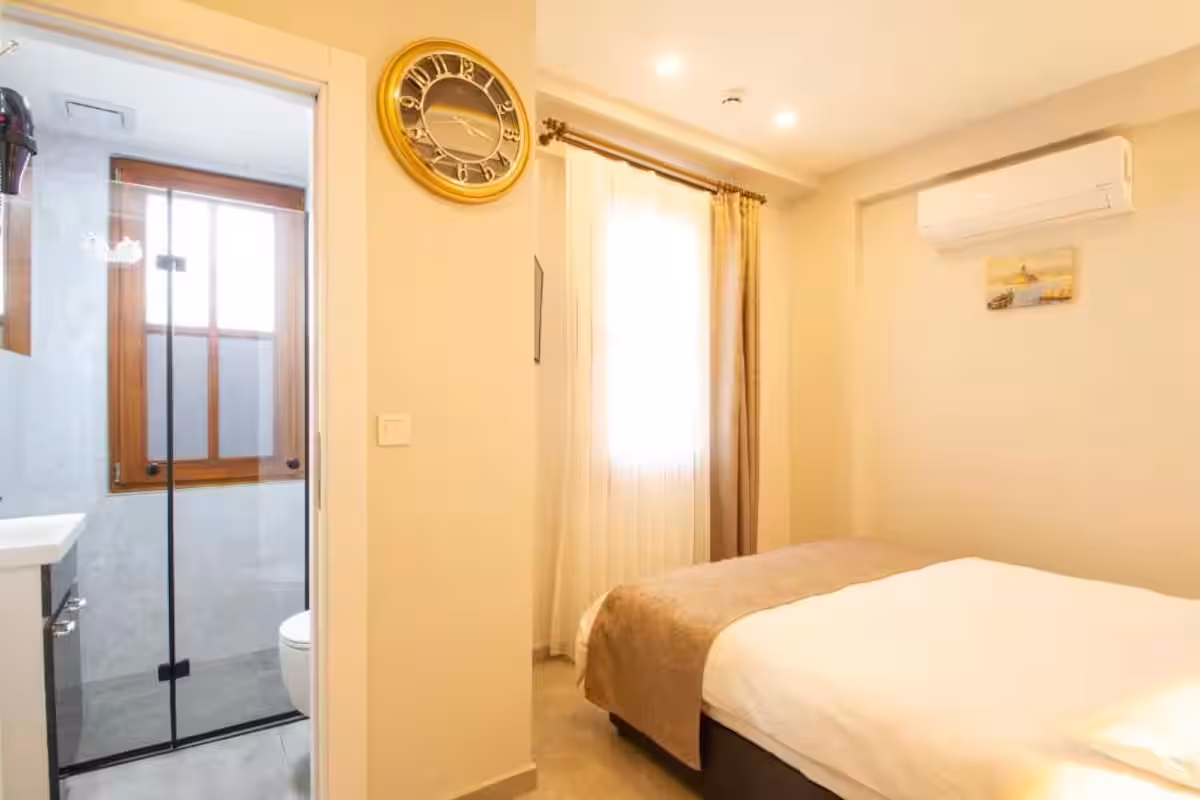 A guest room inside Turna Hotel — the everyday, lived-in warmth of the house